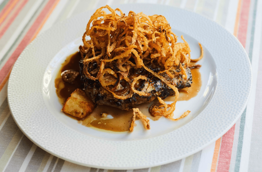 Roast beef with crispy onion rings, gravy, steak potatoes and homemade chopped pickles